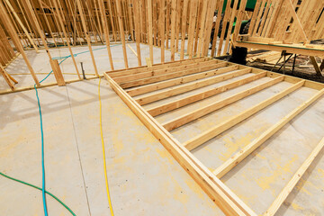 Workers are constructing wooden frame for foundation at construction site on work area