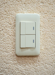 Vertical arrangement of a two-key switch on the wall of a room