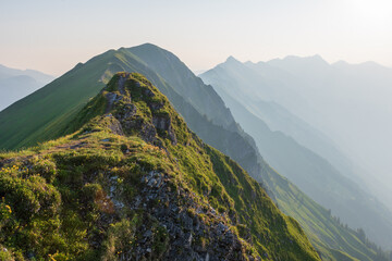 The Berner Oberland region blends dramatic alpine peaks with rolling green hills, dotted with...