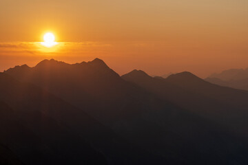 The Berner Oberland region blends dramatic alpine peaks with rolling green hills, dotted with wooden chalets and grazing cows. A picture-perfect Swiss landscape full of charm and serenity.