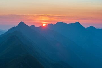 Sunrise on Augstmatthorn, painting the sky in gold above Brienzersee. A peaceful moment above the...