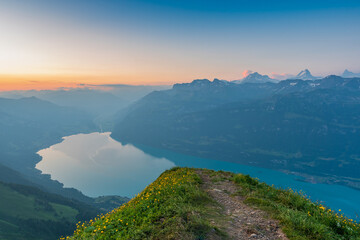 Fototapeta premium Sunrise on Augstmatthorn, painting the sky in gold above Brienzersee. A peaceful moment above the clouds, where silence meets breathtaking alpine beauty.