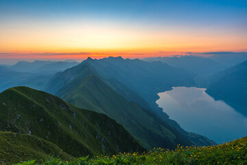 Sunrise on Augstmatthorn, painting the sky in gold above Brienzersee. A peaceful moment above the...