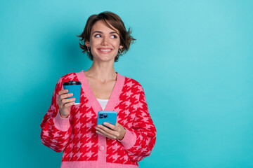 Photo of positive dreamy lady wear pink cardigan drinking coffee texting gadget looking emtpy space...