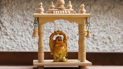 Decorative golden 'Laughing Buddha' showpiece displayed in a shop