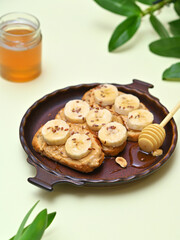 still life with toast with peanut butter, bananas and honey