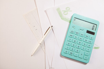 calculator and pen on white background.