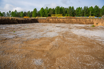 Cleared construction site prepared for building foundation. Excavation area ready for new...