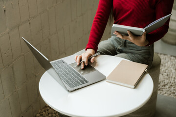 Woman Studying with Laptop and Notebook