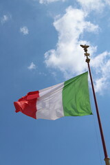 Italian flag in cloudy sky. waving in the sky. Italian flag in a wind on a cloudy blue sky background in Rome