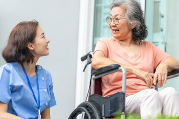 A female caregiver provides compassionate, patient-centric support to a senior woman. Concept for...
