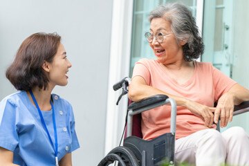 A female caregiver provides compassionate, patient-centric support to a senior woman. Concept for...