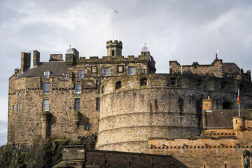 The majestic Edinburgh Castle as seen from the entrance, where warm sunlight highlights the ancient...