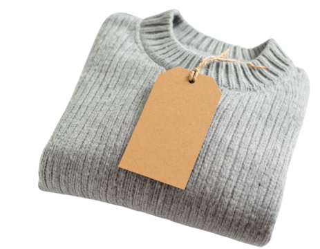 A folded gray sweater with a tag isolated on transparent background
