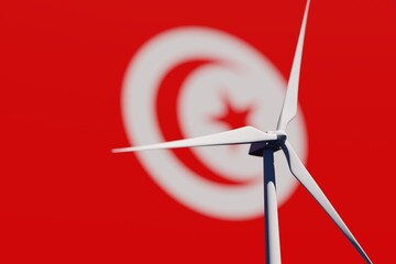 Wind turbine on a background of blurred flag of Tunisia. Wind power concept, selective focus
