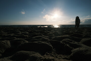 Lonely Figure Watching Sunrise by the Sea