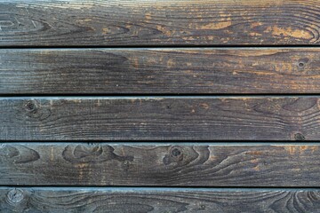 Fototapeta premium Weathered wooden plank wall in dark tones