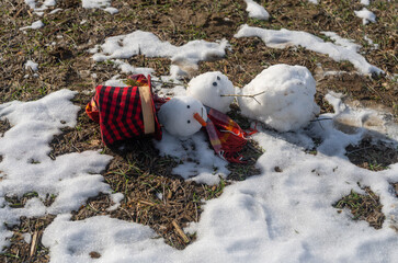 Snowman fading away as warm spring weather arrives. Warm winter weather. End of winter, hello...