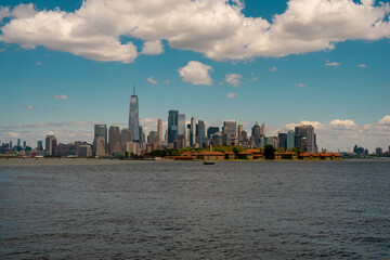 Fototapeta premium New York City. NYC skyline with towering skyscrapers. Manhattan and Hudson River. Panoramic cityscape of New York. Downtown NYC with landmarks. New York skyline. New York reflecting skyscrapers.