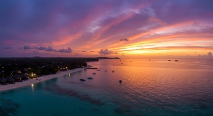 Fototapeta premium Stunning Aerial View of Tropical Sunset Over Ocean and Beach