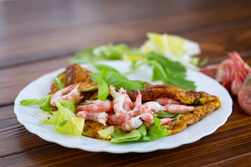 Appetizing breakfast omelette with shrimps and dill