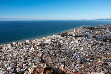 An expansive aerial view of Estepona, showing its dense urban sprawl leading to the extensive...
