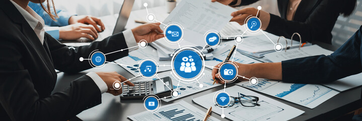 A professional business meeting showcasing teamwork and digital media integration, fostering...