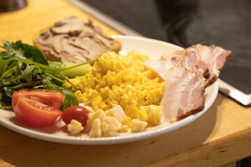breakfast foromelette with vegetables and a sandwich with pate