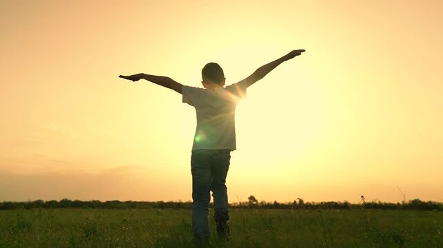 boy son child running airplane game flight dream playground green field sunset, child run pilot family, boy's model airplane, son flying dreams, kid's outdoor aviation, aspiring young flyer, sunset