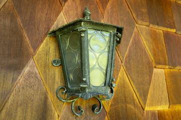 Vintage wall lantern on wooden house facade