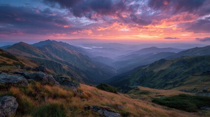 Majestic sunset illuminates carpathian mountains range with dramatic clouds, highlighting the rugged terrain and distant, hazy mountain peaks during twilight