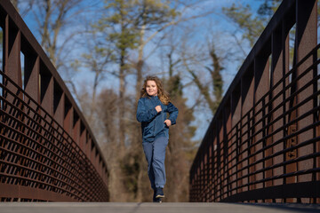 Kid run fast in park. The child runner run and sprint outdoors. Kid run with fun. Outdoor sports...