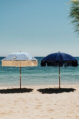 Decorative Beach Umbrellas Beside Calm Ocean on Sunny Day