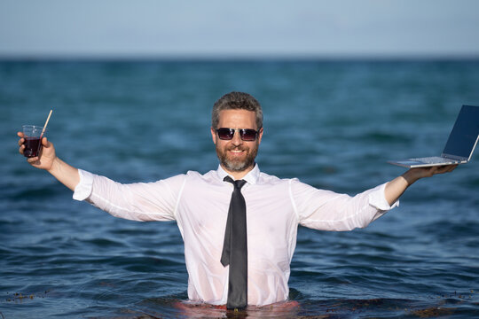 Remote online working on summer sea beach. Business man with laptop during tropical beach vacation. Leisure weekend and remote freelance work. Crazy comic businessman rest on sea beach.