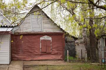 Old Wooden House with Shuttered Window in Vilnius Suburb