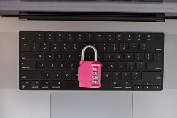 Data protection and strong password concept – pink lock on keyboard for secure online access....