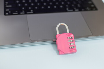 Digital privacy and cyber defense idea, shown by padlock on keyboard, highlighting encryption. Pink...