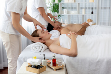 Caucasian couple enjoying relaxing anti-stress head massage and pampering facial beauty skin...