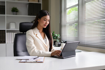 Businessman using tablet to work in home office.