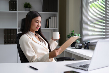 Businessman checking documents in office