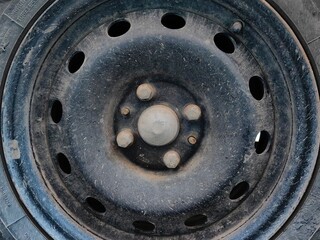 Steel car rims. Old dirty wheel rims with nuts