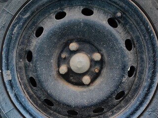 Steel car rims. Old dirty wheel rims with nuts