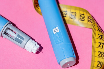 Injection pens for diabetes and obesity control. Minimal flat lay with bright background and tape...