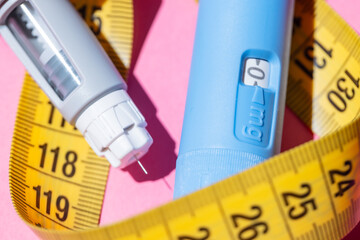 Blue injection pens for diabetes and weight loss. Conceptual healthcare image with bright pastel...