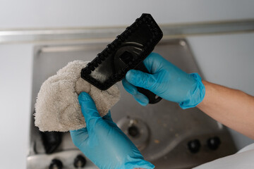 Close-up of unrecognizable man in gloves holding brush and microfiber cloth for steam cleaning...