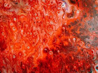 Intense red abstract painting with swirling patterns and circular cell-like shapes, blending into...