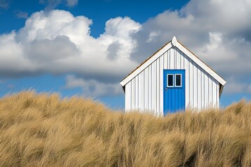 On the Dutch Island of Texel, a white and blue house stands on the beach, accompanied by a beach hut