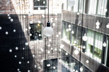 Modern Art Installation of Hanging Light Bulbs in Urban Courtyard


