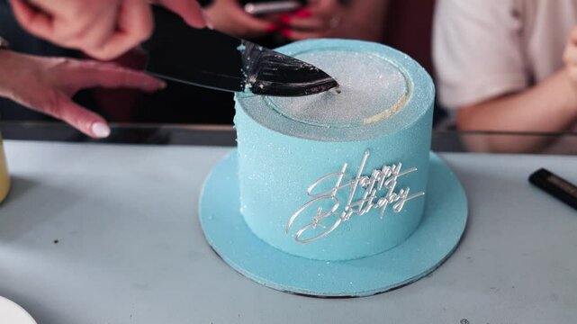 Cutting slice of birthday cake and closeup of knife cutting creamy cake. Delicious fresh homemade cake