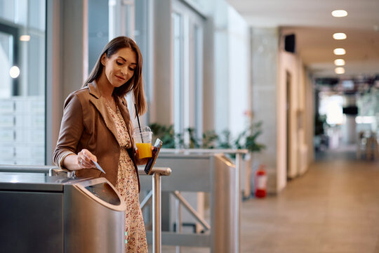 Female entrepreneur using using access card while entering the office building.